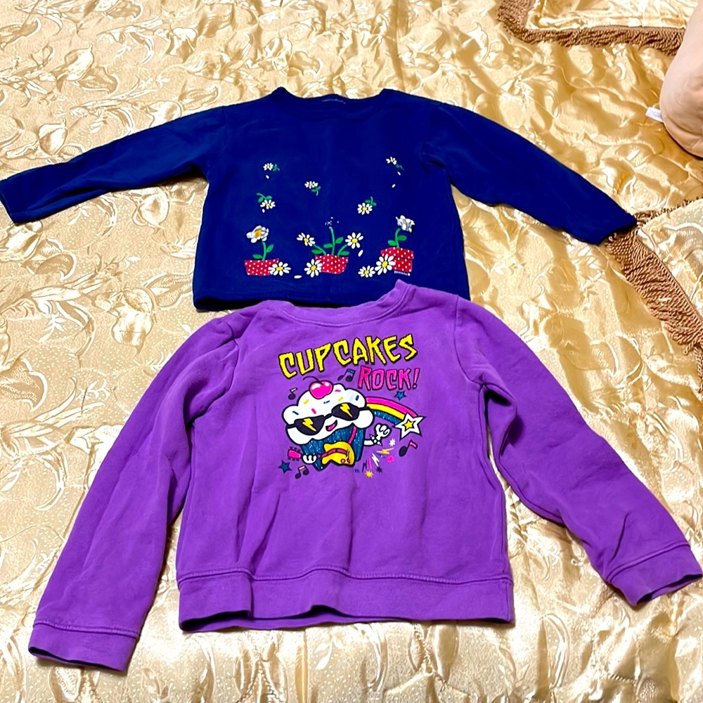 Purple and navy blue sweatshirts. Cupcakes and flowers.